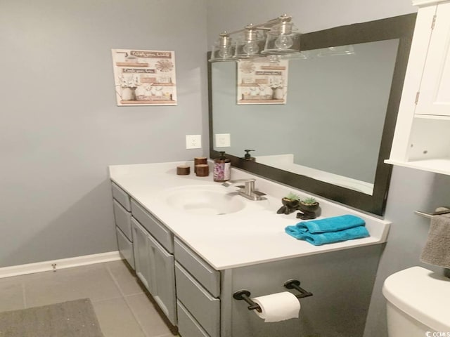 half bath with vanity, toilet, tile patterned flooring, and baseboards