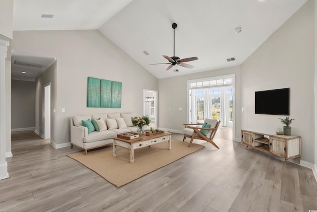 living room featuring ceiling fan, visible vents, light wood-type flooring, high vaulted ceiling, and baseboards