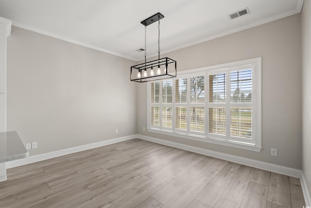 unfurnished dining area with crown molding, light wood finished floors, a chandelier, baseboards, and visible vents