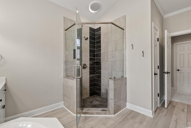 bathroom featuring a shower stall, wood finished floors, and vanity