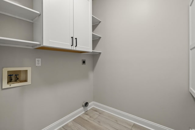 laundry area with hookup for an electric dryer, cabinet space, baseboards, hookup for a washing machine, and light wood-style flooring
