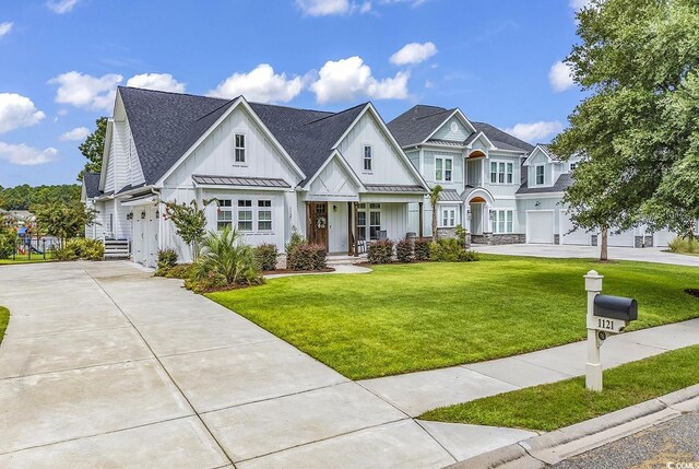 view of front of house with board and batten siding and a front yard