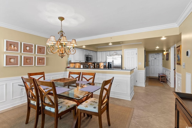 5700 N Ocean Blvd Unit 1107, North Myrtle Beach, SC 29582 - dining area with ornamental molding, a decorative wall, a chandelier, a wainscoted wall, and light tile patterned flooring