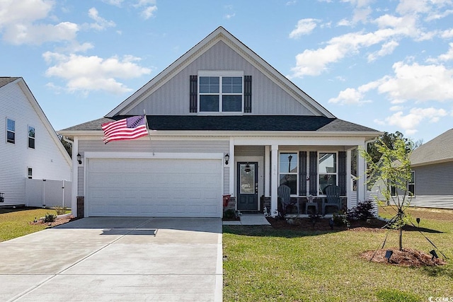 294 Portofino Dr, Myrtle Beach, SC 29579 - view of front of house with a front yard, a porch, driveway, a garage, and board and batten siding