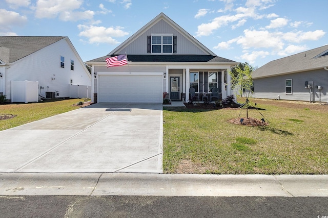 294 Portofino Dr, Myrtle Beach, SC 29579 - view of front of house featuring concrete driveway, a front yard, and board and batten siding