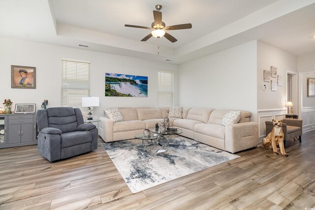294 Portofino Dr, Myrtle Beach, SC 29579 - living room featuring light wood finished floors, a ceiling fan, and a raised ceiling
