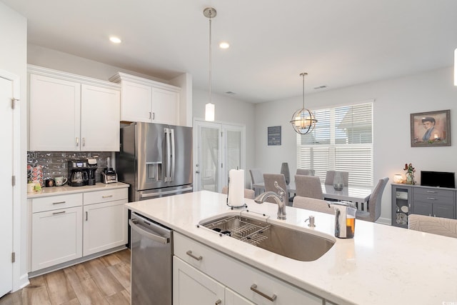 294 Portofino Dr, Myrtle Beach, SC 29579 - kitchen with appliances with stainless steel finishes, white cabinets, pendant lighting, light wood-type flooring, and recessed lighting