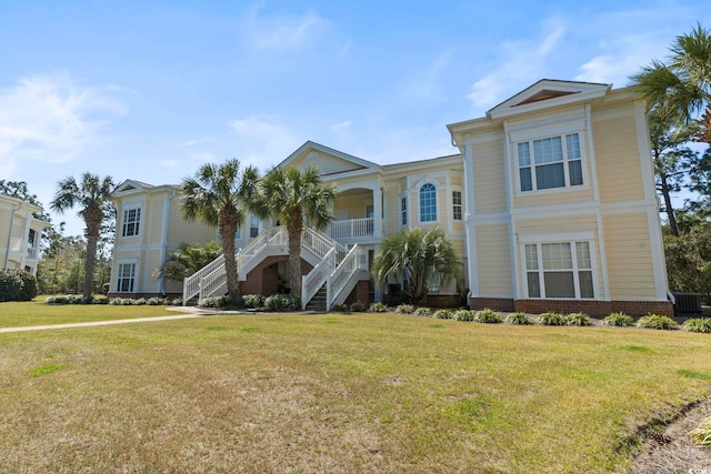 77 Tern Pl Unit 202, Pawleys Island, SC 29585 - view of front of house featuring stairs, a front yard, and a porch