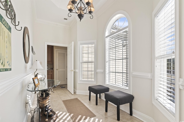 77 Tern Pl Unit 202, Pawleys Island, SC 29585 - sitting room featuring light tile patterned floors, a chandelier, crown molding, and a high ceiling