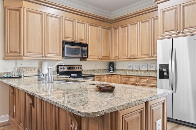 77 Tern Pl Unit 202, Pawleys Island, SC 29585 - kitchen featuring appliances with stainless steel finishes, light stone countertops, a peninsula, light wood-style floors, and ornamental molding