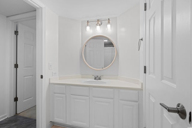 bathroom with vanity and wood finished floors