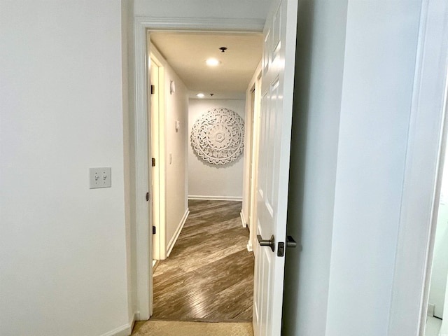 hallway featuring recessed lighting, baseboards, and wood finished floors