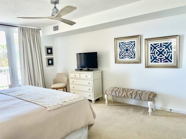 bedroom with access to outside, light carpet, a textured ceiling, and visible vents