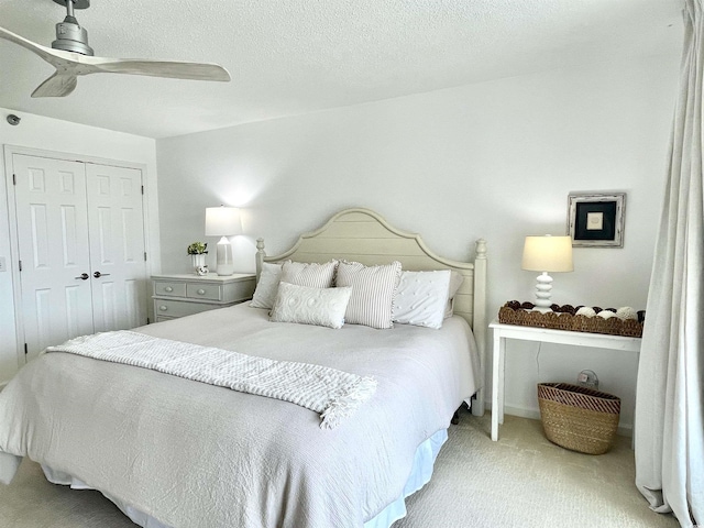 bedroom with a ceiling fan, carpet, and a closet