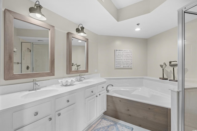 bathroom with a sink, tile patterned flooring, a garden tub, and a stall shower