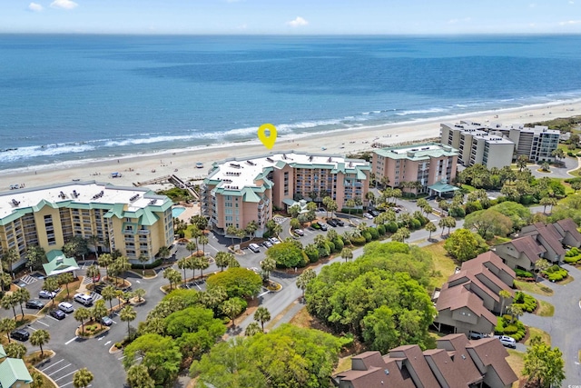 birds eye view of property with a water view and a view of the beach
