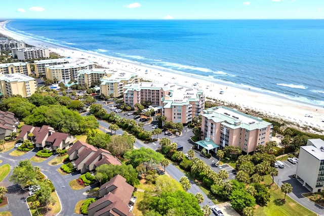 drone / aerial view with a beach view and a water view