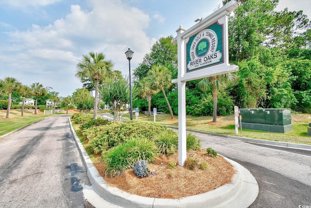 view of road featuring street lights and curbs