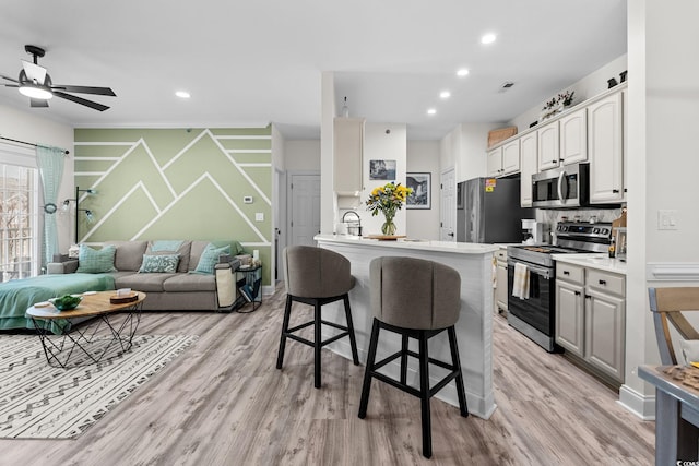 2013 Silvercrest Dr Unit 30-F, Myrtle Beach, SC 29579 - kitchen featuring appliances with stainless steel finishes, a breakfast bar, open floor plan, a peninsula, and light wood finished floors