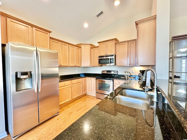 1612 Fairforest Ct, Conway, SC 29526 - kitchen featuring appliances with stainless steel finishes, light brown cabinetry, vaulted ceiling, dark stone countertops, and recessed lighting