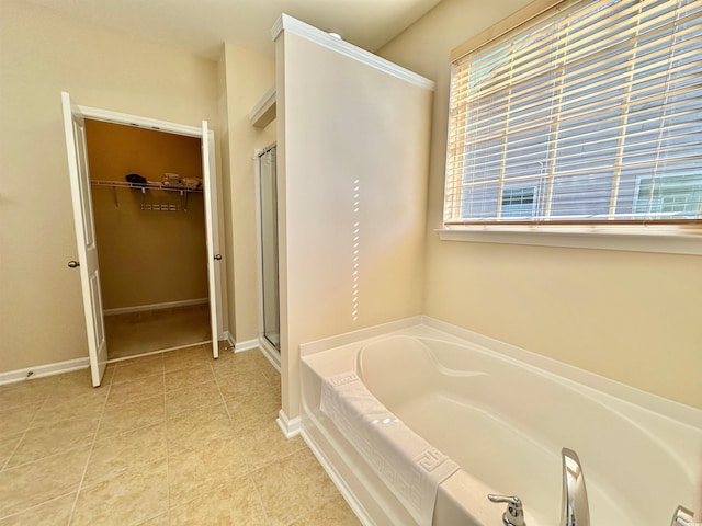 1612 Fairforest Ct, Conway, SC 29526 - bathroom featuring a garden tub, a stall shower, a walk in closet, and tile patterned floors