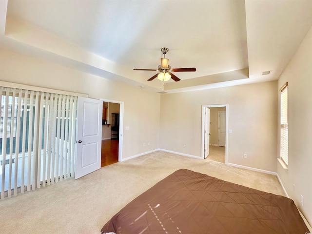 1612 Fairforest Ct, Conway, SC 29526 - empty room featuring a raised ceiling, light carpet, and ceiling fan