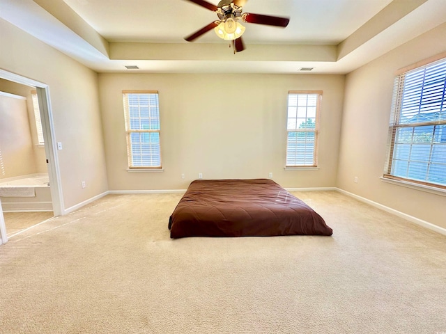1612 Fairforest Ct, Conway, SC 29526 - bedroom featuring a tray ceiling, light colored carpet, ceiling fan, and ensuite bathroom