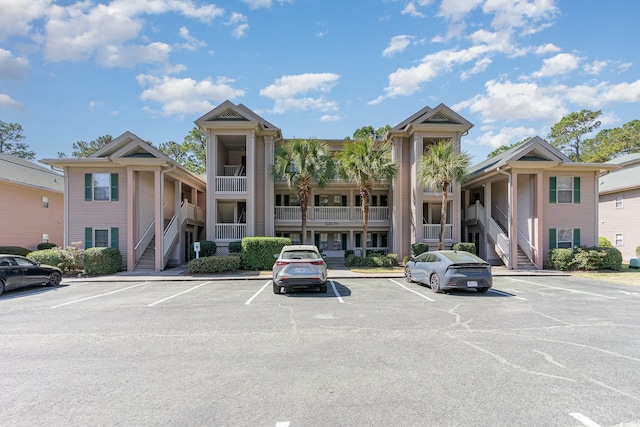 478 Pinehurst Ln Unit 17D, Pawleys Island, SC 29585 - view of property featuring uncovered parking and stairway