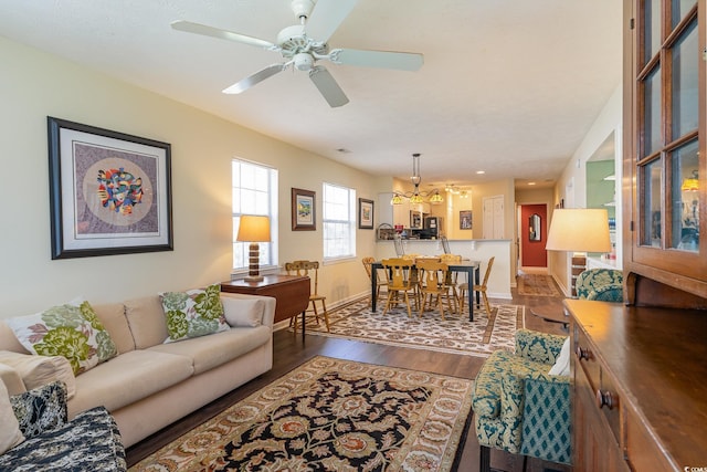 478 Pinehurst Ln Unit 17D, Pawleys Island, SC 29585 - living room with dark wood-style flooring, ceiling fan, baseboards, and a chandelier