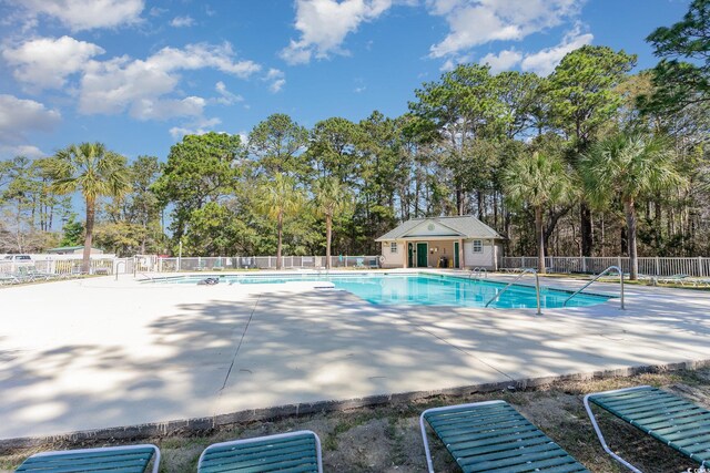 478 Pinehurst Ln Unit 17D, Pawleys Island, SC 29585 - community pool featuring a patio and view of wooded area