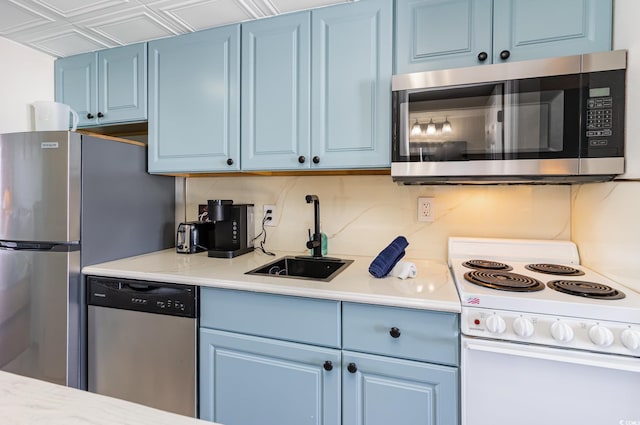 2001 S Ocean Blvd Unit 1505, Myrtle Beach, SC 29577 - kitchen with light countertops, a sink, blue cabinetry, and stainless steel appliances