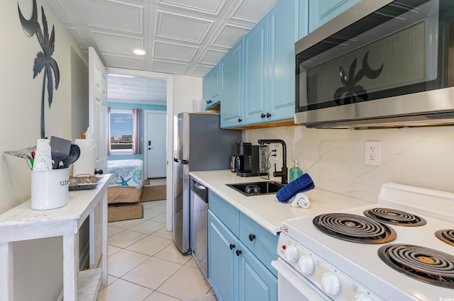 2001 S Ocean Blvd Unit 1505, Myrtle Beach, SC 29577 - kitchen with light tile patterned floors, light countertops, appliances with stainless steel finishes, and blue cabinets