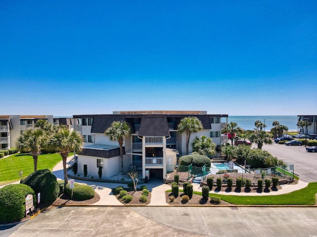 5601 N Ocean Blvd Unit C-311, Myrtle Beach, SC 29577 - view of building exterior featuring a water view and fence