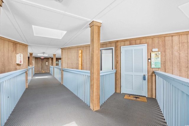 5601 N Ocean Blvd Unit C-311, Myrtle Beach, SC 29577 - corridor with carpet floors, wooden walls, and a skylight