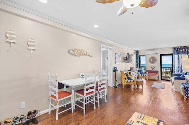 5601 N Ocean Blvd Unit C-311, Myrtle Beach, SC 29577 - dining space featuring a wall mounted AC, ornamental molding, baseboards, a ceiling fan, and wood finished floors