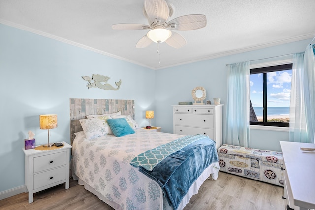 5601 N Ocean Blvd Unit C-311, Myrtle Beach, SC 29577 - bedroom with baseboards, light wood-type flooring, crown molding, and a ceiling fan