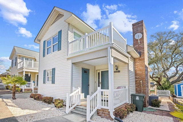 600-B 43rd Ave S, North Myrtle Beach, SC 29582 - view of front of property featuring a balcony, a chimney, and covered porch