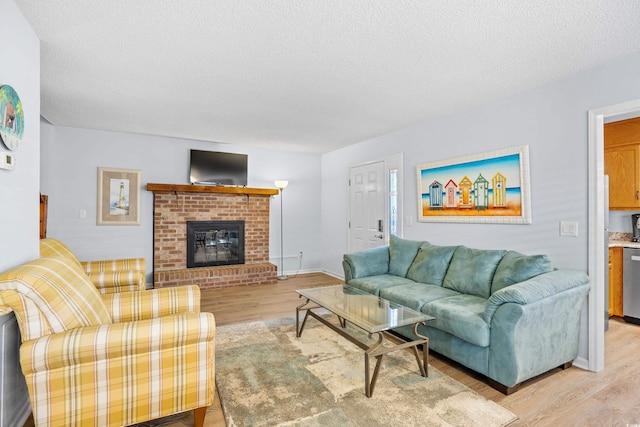 600-B 43rd Ave S, North Myrtle Beach, SC 29582 - living area with light wood-style floors, a textured ceiling, and a brick fireplace