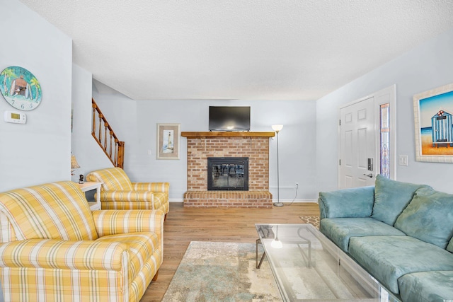 600-B 43rd Ave S, North Myrtle Beach, SC 29582 - living area featuring light wood-type flooring, stairway, a fireplace, and a textured ceiling