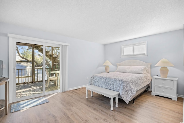 600-B 43rd Ave S, North Myrtle Beach, SC 29582 - bedroom featuring access to exterior, light wood-style flooring, and a textured ceiling