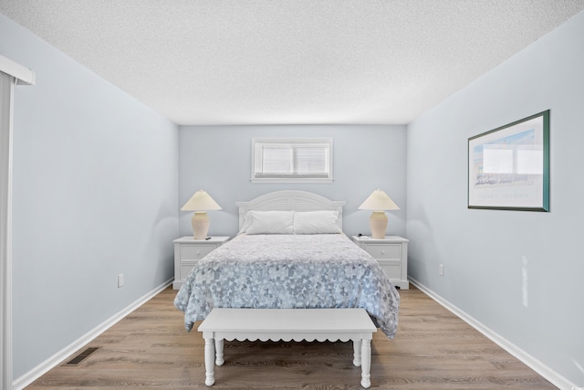 600-B 43rd Ave S, North Myrtle Beach, SC 29582 - bedroom featuring a textured ceiling and light wood finished floors