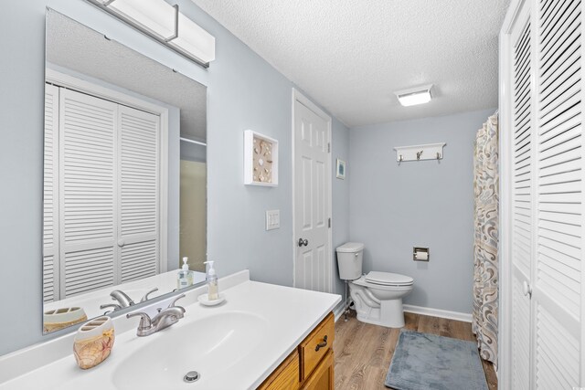 600-B 43rd Ave S, North Myrtle Beach, SC 29582 - bathroom featuring a closet, wood finished floors, vanity, a textured ceiling, and curtained shower