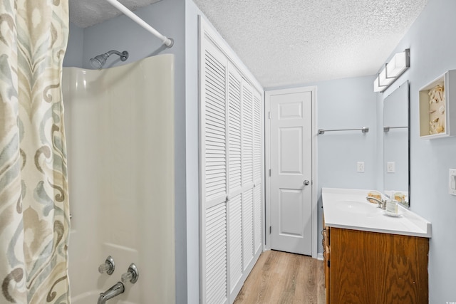 600-B 43rd Ave S, North Myrtle Beach, SC 29582 - bathroom with a closet, a textured ceiling, vanity, wood finished floors, and shower / bath combo with shower curtain