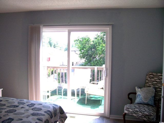 600-B 43rd Ave S, North Myrtle Beach, SC 29582 - bedroom featuring multiple windows and access to exterior