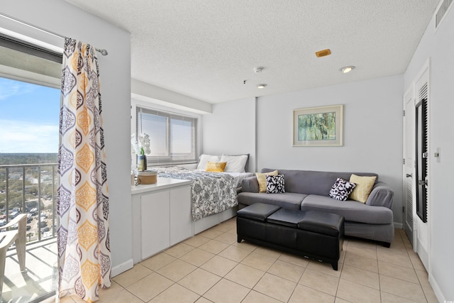 bedroom featuring visible vents, a textured ceiling, and light tile patterned floors