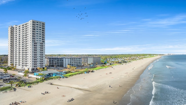 birds eye view of property with a water view and a view of the beach