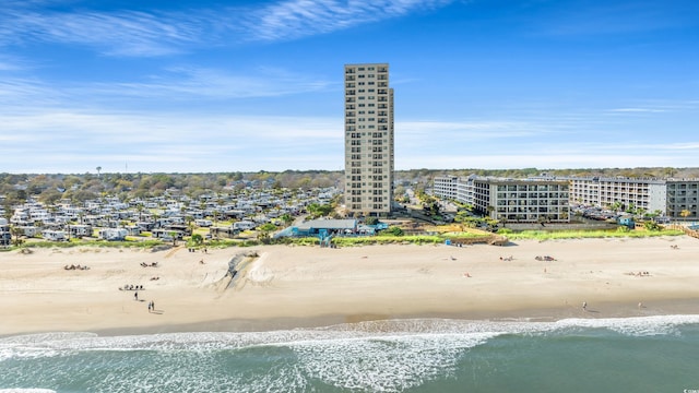drone / aerial view featuring a water view and a view of the beach