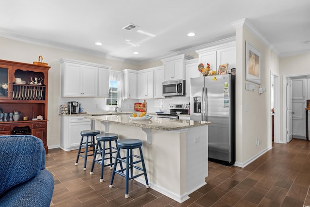 100 Marblehead Dr, Little River, SC 29566 - kitchen featuring stainless steel appliances, white cabinets, a center island, dark wood-type flooring, and ornamental molding