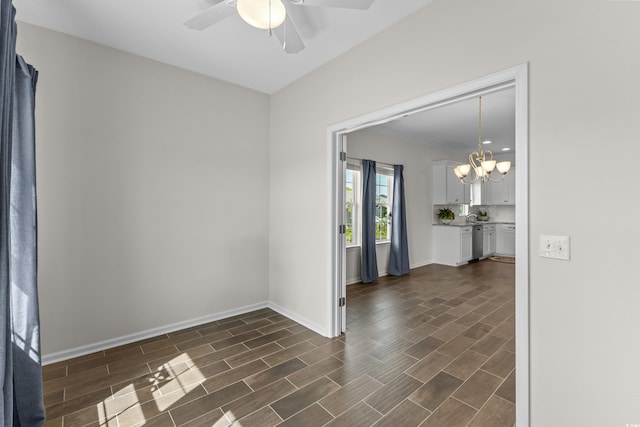 100 Marblehead Dr, Little River, SC 29566 - spare room featuring a ceiling fan, a chandelier, and dark wood-type flooring