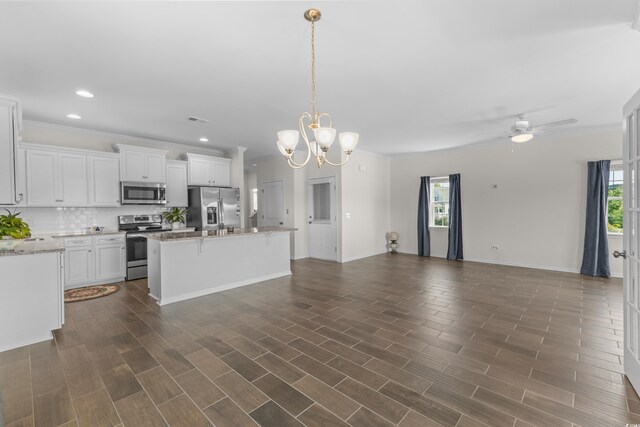 100 Marblehead Dr, Little River, SC 29566 - kitchen with stainless steel appliances, open floor plan, tasteful backsplash, crown molding, and a center island